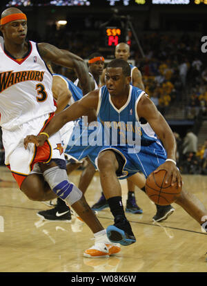 New Orleans Hornets Chris Paul (R) drives on  Golden State Warriors Al Harrington (L) in the first half at the Oracle Arena in Oakland, California on October 29, 2008.   (UPI Photo/Terry Schmitt) Stock Photo