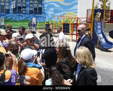 First Lady Michelle Obama and California First Lady Maria Shriver talk to students at Bret Harte Elementary School in San Francisco on June 22, 2009. The two paid a visit to a playground being built by volunteers.   (UPI Photo/Terry Schmitt) Stock Photo