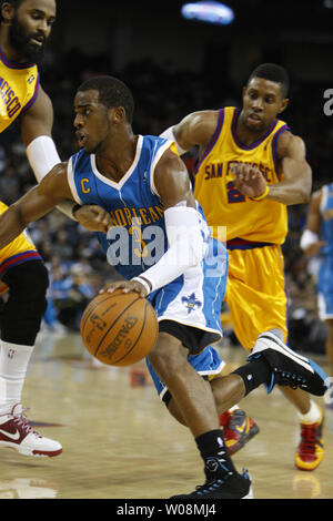 New Orleans Hornets Chris Paul (3) drives past Golden State Warriors  Ronny Turiaf (L) and C.J. Watson in the second half at the Oracle Arena in Oakland, California on January 27, 2010.  The Hornets defeated the Warriors 123-110.    UPI/Terry Schmitt Stock Photo