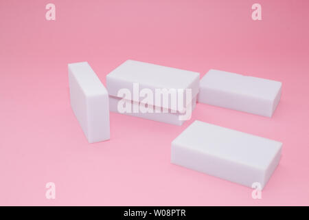 Melamine household sponge stack with four sponges for cleaning on pink background. Cleaning concept Stock Photo