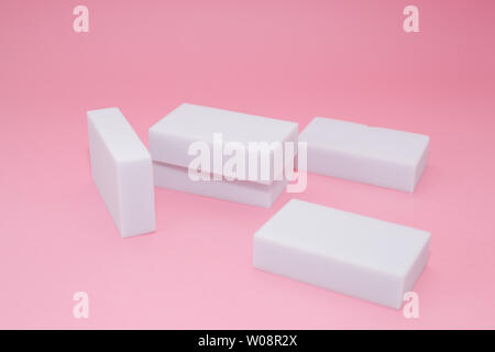 Melamine household sponge stack with four sponges for cleaning on pink background. Cleaning concept Stock Photo