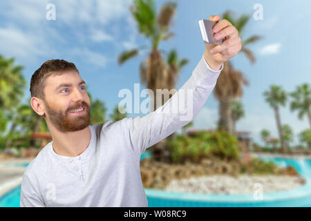 Cheerful young man making photo of himself Stock Photo