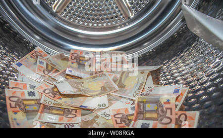 Euros inside washing machine. Concept for money laundering Stock Photo