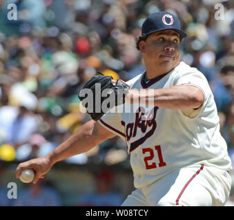 Oakland A's pitcher Bartolo Colon throws to the Seattle Mariners