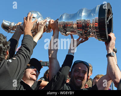 Team members hoist the trophy after Oracle Team USA won the final race of the America's Cup Regatta against Emirates New Zealand in San Francisco on September 25, 2013. The Americans defeated the challenger Kiwis 9-8 after being down 8-1.   UPI/Terry Schmitt Stock Photo