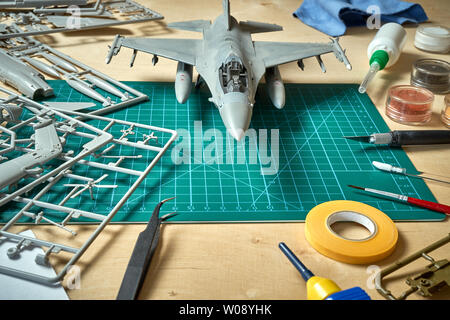 Top view on plastic model scale with accessories on  green pad on  wooden table Stock Photo