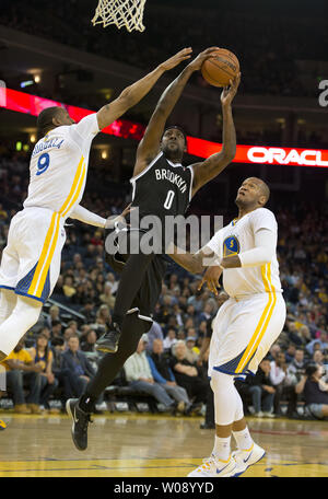 Brooklyn Nets Andray Blatche (0) goes against Golden State Warriors Andre Iguodala (9) and Marreese Speights (5) in the first half at Oracle Arena in Oakland, California on February 22, 2014.  UPI/Terry Schmitt Stock Photo