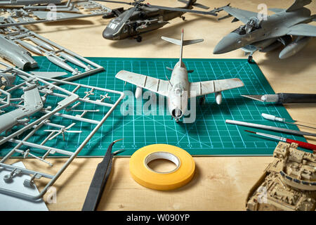 Top view on plastic model scale with accessories on  green pad on  wooden table Stock Photo