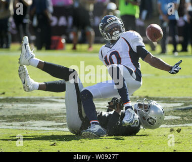 Denver Broncos Emmanuel Sanders (R) tries to hold on to a Peyton Manning pass as he is hit by Oakland Raiders David Amerson (29) in the third quarter at O.co Coliseum in Oakland, California on October 11, 2015. The Broncos defeated the Raiders 16-10.  Photo by Terry Schmitt/UPI Stock Photo
