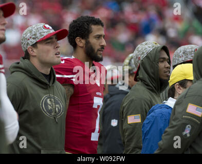 San Francisco 49ers tight ends Vance McDonald (89) and Garrett Celek (88)  take a knee following guard, Mike Iupati's (77) game ending injury during  the NFC Championship Game against the Seattle Seahawks