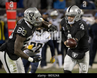 Oakland Raiders quarterback Derek Carr (4) hands off to Latavius Murray  in the first quarter against the San Diego Chargers at O.co Coliseum in Oakland, California on December 24, 2015. The Raiders defeated the Chargers 23-20 in overtime.    Photo by Terry Schmitt/UPI Stock Photo