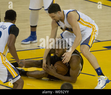 Golden State Warriors Klay Thompson ties up San Antonio Spurs Kawhi Leonard in the second half at Oracle Arena in Oakland, California on April 7, 2016. The Warriors defeated the Spurs 112-101 to clinch top seed for the playoffs.     Photo by Terry Schmitt/UPI Stock Photo