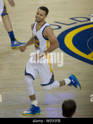 Stephen Curry (30) smiles after making another of his circus shots