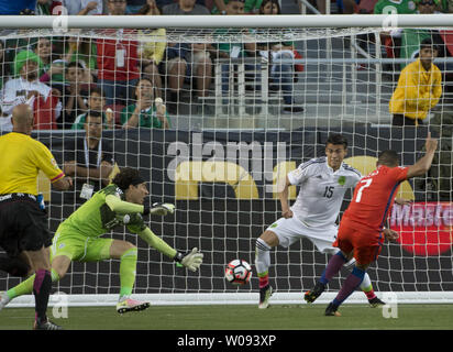 Chile's Alexis Sanchez (7) puts in a goal against Mexico's goalie Guillermo Ochoa (L) in the second half at COPA America Centenario quarter-finals at Levi's Stadium in Santa Clara, California on June 18,  2016. Chile annihilated Mexico 7-0.   Photo by Terry Schmitt/UPI Stock Photo