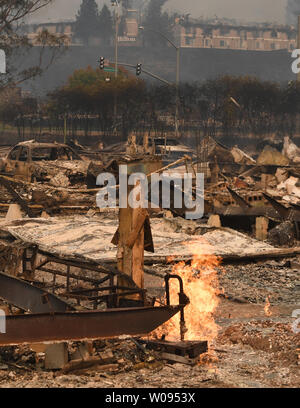 Live gas jets shoot up from the ruins of Journey's End Trailer Park after wildfires fueled by wind and low humidity destroyed it in Santa Rosa, California on October 9, 2017. The Hilton Hotel, also destroyed sits on the hill behind. Photo by Terry Schmitt/UPI Stock Photo