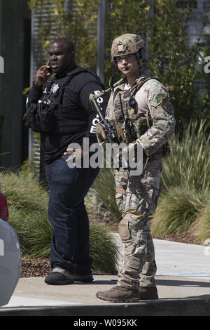 Police and Sheriff's deputies patrol the perimeter outside an active shooter incident at YouTube headquarters in San Bruno, California on April 3, 2018.     Photo by Terry Schmitt Stock Photo