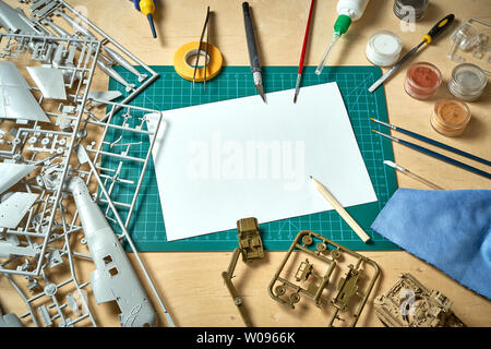 Top view on plastic model scale with accessories on  green pad on  wooden table Stock Photo