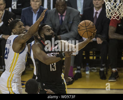 Houston Rockets guard James Harden (13) lays up a shot in front of Golden State Warriors forward Alfonzo McKinnie (28) in the first quarter of game one of the Western Conference Semi-Finals of NBA Playoffs at Oracle Arena in Oakland, California on April 28, 2019.      Photo by Terry Schmitt/UPI Stock Photo