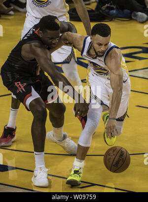Golden State Warriors guard Stephen Curry (30) goes for a rebound against Houston Rockets center Clint Capela (15) in the second half of game one of the Western Conference Semi-Finals of NBA Playoffs at Oracle Arena in Oakland, California on April 28, 2019. The Warriors defeated the Rockets 104-100.     Photo by Terry Schmitt/UPI Stock Photo
