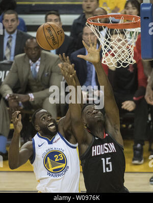 Golden State Warriors forward Draymond Green (23) and Houston Rockets center Clint Capela (15) go for a rebound in the first half of game 5 of the Western Conference Semifinals at Oracle Arena in Oakland, California on May 8, 2019. The Warriors defeated the Rockets 104-99 to go up three games to two.  Photo by Terry Schmitt/UPI Stock Photo