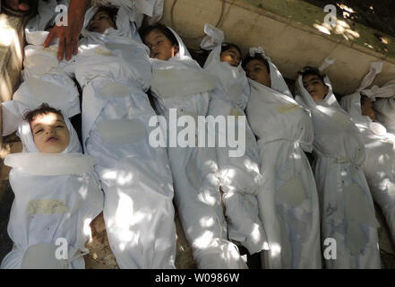 Dead children lie on the ground as Syrian rebels claim they were killed in a toxic gas attack by pro-government forces in eastern Ghouta, on the outskirts of Damascus in Syria on August 21, 2013.   The Syrian government has denied the claims from the opposition that it has used chemical weapons. The UN is investigating.   UPI/Diaa El Din Stock Photo
