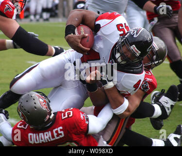 Atlanta Falcons running back T. J. Duckett (45) pushes past the Tampa Bay  Buccaneers defense including linebacker Shelton Quarles (53) for the first  of two first half touchdowns at the Georgia Dome