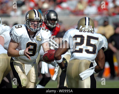 New Orleans Saints and former San Diego quarterback Drew Brees and General  Manager Mickey Loomis, right, hold a Saints jersey presented to Brees  during a news conference at the New Orleans Saints