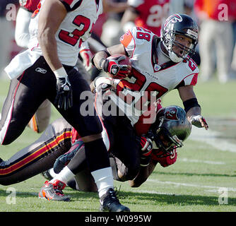 Tampa Bay Buccaneers' linebacker Shelton Quarles (53) tackles Seattle  Seahawks' running back Shaun Alexander as Seahawks' tight end Jerramy  Stevens (86) blocks Buccaneers' defensive end Greg Spires (94) at Raymond  James Stadium