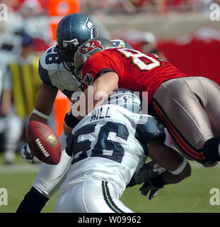 Tampa Bay Buccaneers' linebacker Shelton Quarles (53) tackles Seattle  Seahawks' running back Shaun Alexander as Seahawks' tight end Jerramy  Stevens (86) blocks Buccaneers' defensive end Greg Spires (94) at Raymond  James Stadium