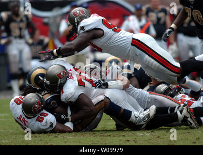 Tampa Bay Buccaneers' linebacker Cato June (59) and defensive tackles Jovan Haye (71) and Kevin Carter (93) slam St. Louis Rams' running back Steven Jackson (39) at Raymond James Stadium in Tampa, Florida on September 23, 2007. The Buccaneers beat the Rams 24-3.   (UPI Photo/Cathy Kapulka) Stock Photo