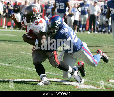 Tampa Bay Buccaneers running back Earnest Graham (34) is tackled by New York Giants linebacker Antonio Pierce (59) in first half action in their first round NFC Wildcard playoff game at Raymond James Stadium in Tampa, Florida on December 6, 2007. (UPI Photo/Michael Bush) Stock Photo