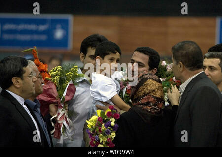 Iranian nuclear scientist Shahram Amiri arrives and is greeted by relatives and friends after arriving at Imam Khomeini airport in Tehran, Iran on July 15, 2010.  He is holding his 7-year-old son Amir Hossein.  Amiri claimed he was adducted by American agents last year while the U.S. says he was a willing defector who changed his mind.       UPI/Maryam Rahmanian Stock Photo