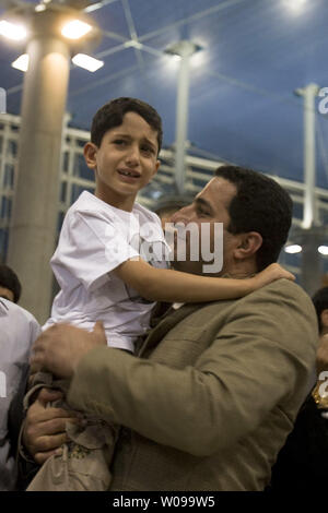 Iranian nuclear scientist Shahram Amiri arrives and is greeted by relatives and friends after arriving at Imam Khomeini airport in Tehran, Iran on July 15, 2010.  He is holding his 7-year-old son Amir Hossein.  Amiri claimed he was adducted by American agents last year while the U.S. says he was a willing defector who changed his mind.       UPI/Maryam Rahmanian Stock Photo