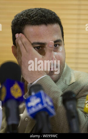 Iranian nuclear scientist Shahram Amiri answers the questions of the reporters after arriving at Imam Khomeini airport in Tehran, Iran on July 15, 2010.  He is holding his 7-year-old son Amir Hossein.  Amiri claimed he was abducted by American agents last year while the U.S. says he was a willing defector who changed his mind.       UPI/Maryam Rahmanian Stock Photo