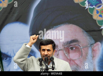 Iranian President Mahmoud Ahmadinejad speaks in front of the pictures of Iran's late leader Ayatolah Khomeini (L) and Iran's current Leader Ayatolah Khamenei  during the 32nd  anniversary of the Islamic Revolution in Tehran, Iran on February 11, 2011.     UPI/Maryam Rahmanian. Stock Photo