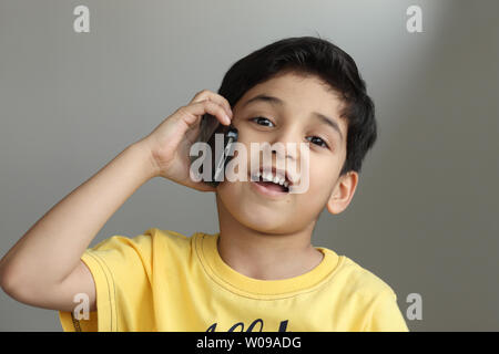 Portrait of a boy talking on a mobile phone Stock Photo