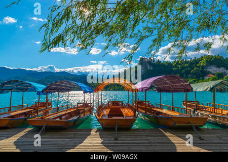 Colorful boats on the lake. Summer scene on the Bled Lake in Slovenia. Popular travel destination in Europe Stock Photo