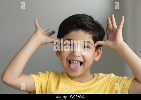 Indian boy making a funny face Stock Photo - Alamy