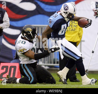 Jacksonville Jaguars strong safety Donovin Darius (left) pushed Tennessee Titans wide receiver Derrick Mason out of bounds after a 25-yard gain with 8:30 left in the first quarter of an NFL game on Sunday, Nov. 16, 2003 at The Coliseum in Nashville, Tenn.  Mason caught five passes for 89 yards in Tennessee's 10-3 win. (UPI Photo/Billy Suratt) Stock Photo