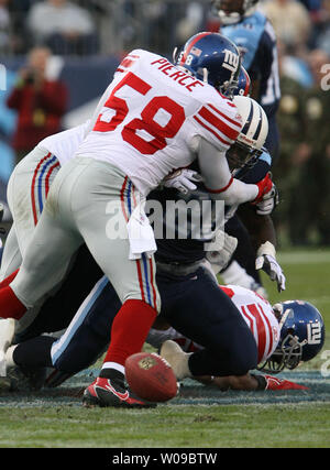 New York Giants linebacker Antonio Pierce (58) causes Tennessee Titans runningback Travis Henry (20) to fumble the ball at LP Field in Nashville, Tennessee on November 26, 2006. The Titans defeated the Giants 24-21.  (UPI Photo/Frederick Breedon IV) Stock Photo