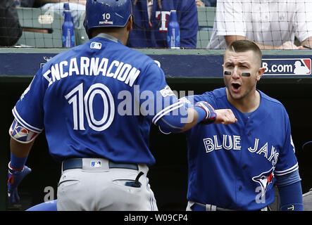Toronto Blue Jays' Edwin Incarnation (10) is congratulated by Troy Tulowitzki after hitting a home run against the Texas Rangers in the fifth inning of game 2 of the American League Division Series at Globe Life Park in Arlington, Texas on October 7, 2016. Toronto defeated Texas 11-1.  Photo by Mike Stone/UPI Stock Photo