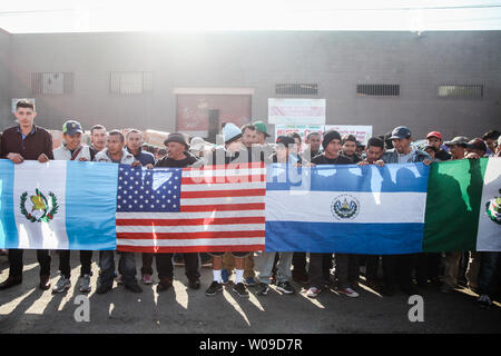 Migrants who traveled from Central America hold various flags in Tijuana, Mexico, to represent their country along with the United States flag to represent where they would like to start their new life on December 23, 2018.  The U.S. government is in a partial shutdown after President Trump refused to sign a bipartisan agreement, holding out for $5 billion to build an expanded border wall.    Photo by Ariana Drehsler/UPI Stock Photo