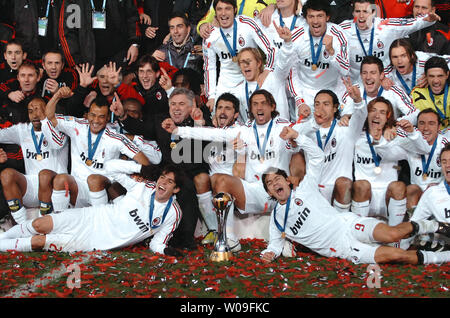 Players of Italian AC Milan poses with the champion trophy after