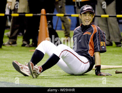 Combined photo shows Japanese outfielder Ichiro Suzuki of the Miami Marlins  wearing different T-shirts during the Major League Baseball club's spring  training in Jupiter, Florida, in 2015. The T-shirt on the bottom