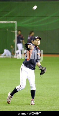 Combined photo shows Japanese outfielder Ichiro Suzuki of the Miami Marlins  wearing different T-shirts during the Major League Baseball club's spring  training in Jupiter, Florida, in 2015. The T-shirt on the bottom