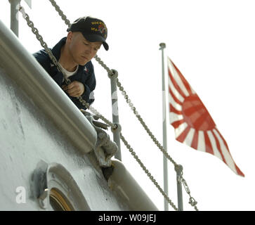 The crew of USS Nimitz paint Japan's historic battleship Mikasa at Yokosuka, Japan on August 25, 2009.  U.S. Admiral Chester W. Nimitz spearheaded a restoration movement of the Mikasa, built in 1900, after World War II to honor Japanse Admiral Heihachiro Togo, who won the battle of Tsushima with the Mikasa during the Russo-Japanese war in 1905.      UPI/Keizo Mori Stock Photo