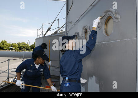 The crew of USS Nimitz paint Japan's historic battleship Mikasa at Yokosuka, Japan on August 25, 2009.  U.S. Admiral Chester W. Nimitz spearheaded a restoration movement of the Mikasa, built in 1900, after World War II to honor Japanse Admiral Heihachiro Togo, who won the battle of Tsushima with the Mikasa during the Russo-Japanese war in 1905.      UPI/Keizo Mori Stock Photo
