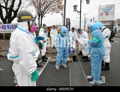 Member of Japan's Ground Self Defense Force decontaminate at the city office of Namie Machi,  8 kilometers from the Fukushima Dai-ichi nuclear power plant in Fukushima prefecture, Japan, on December 8, 2011. About 900 members of Japan's GSFD started a two-week decontamination operation.   UPI/Keizo Mori Stock Photo