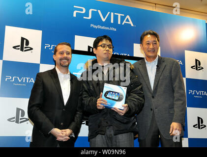 (L-R) Chairman of Sony Computer Entertainment, Inc., Kazuo Hirai, first customer and President and Group CEO of Sony Computer Entertainment Inc., Andrew House pose for camera during a launch event for portable video game player 'PlayStation Vita (PS VITA)' at the 'TSUTAYA' Shibuya store in Tokyo, Japan, on December 17, 2011. PS VITA will be released in Europe and U.S. on February 22, 2012.     UPI/Keizo Mori Stock Photo