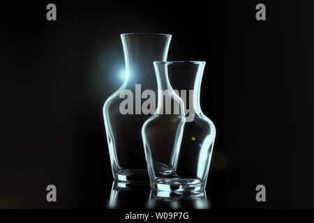 Outline of two glass vases on a black background, horizontal layout. flares. Stock Photo